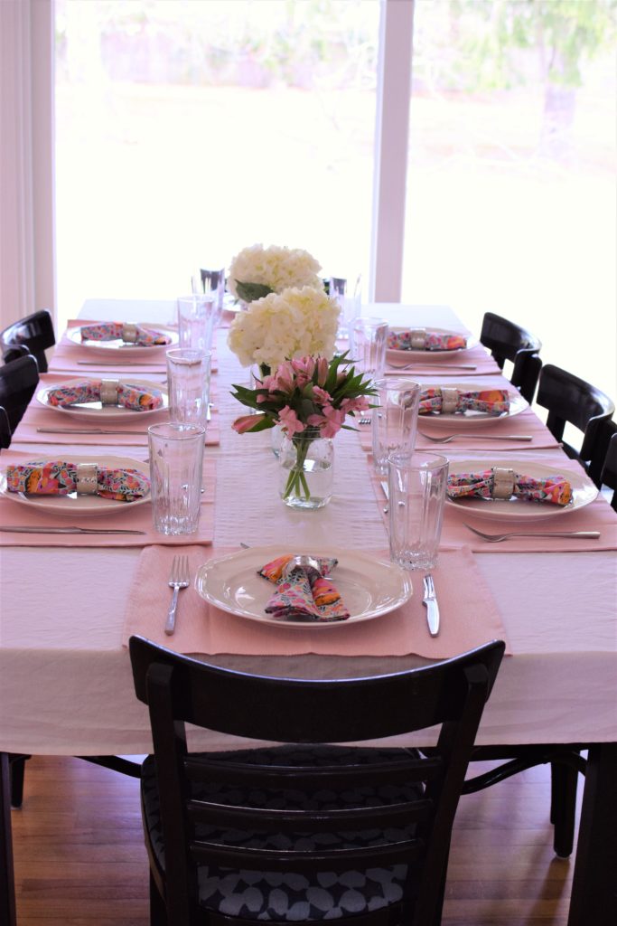Simple, cheap, easy to put together blush easter table with colorful napkins. This Easter Tablescape is light and airy like spring. 