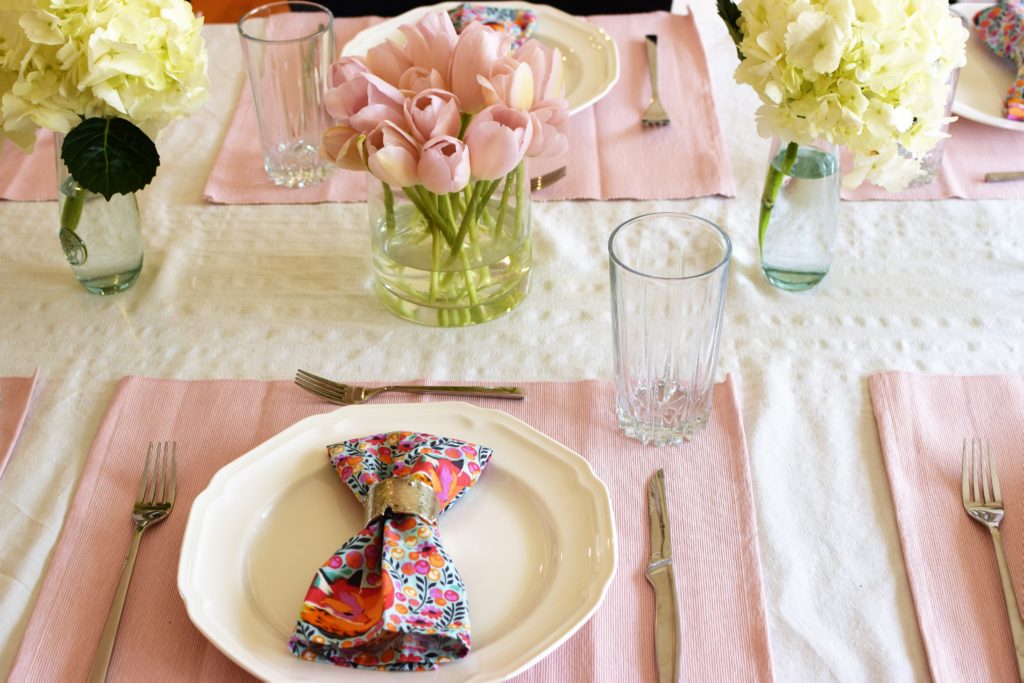 Simple, cheap, easy to put together blush easter table with colorful napkins. This Easter Tablescape is light and airy like spring. 