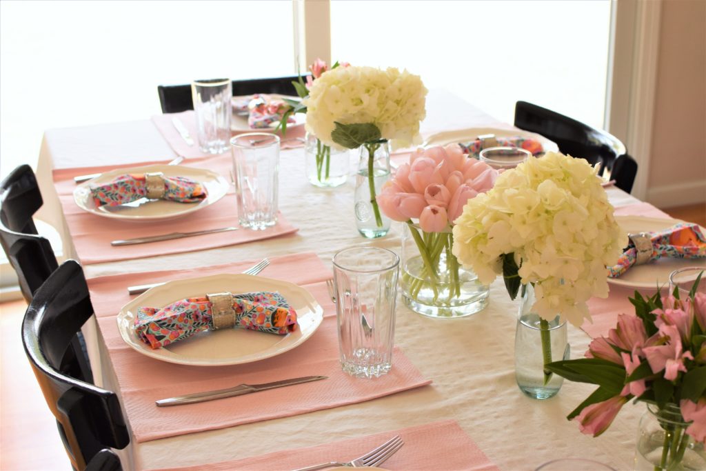 Simple, cheap, easy to put together blush easter table with colorful napkins. This Easter Tablescape is light and airy like spring. 